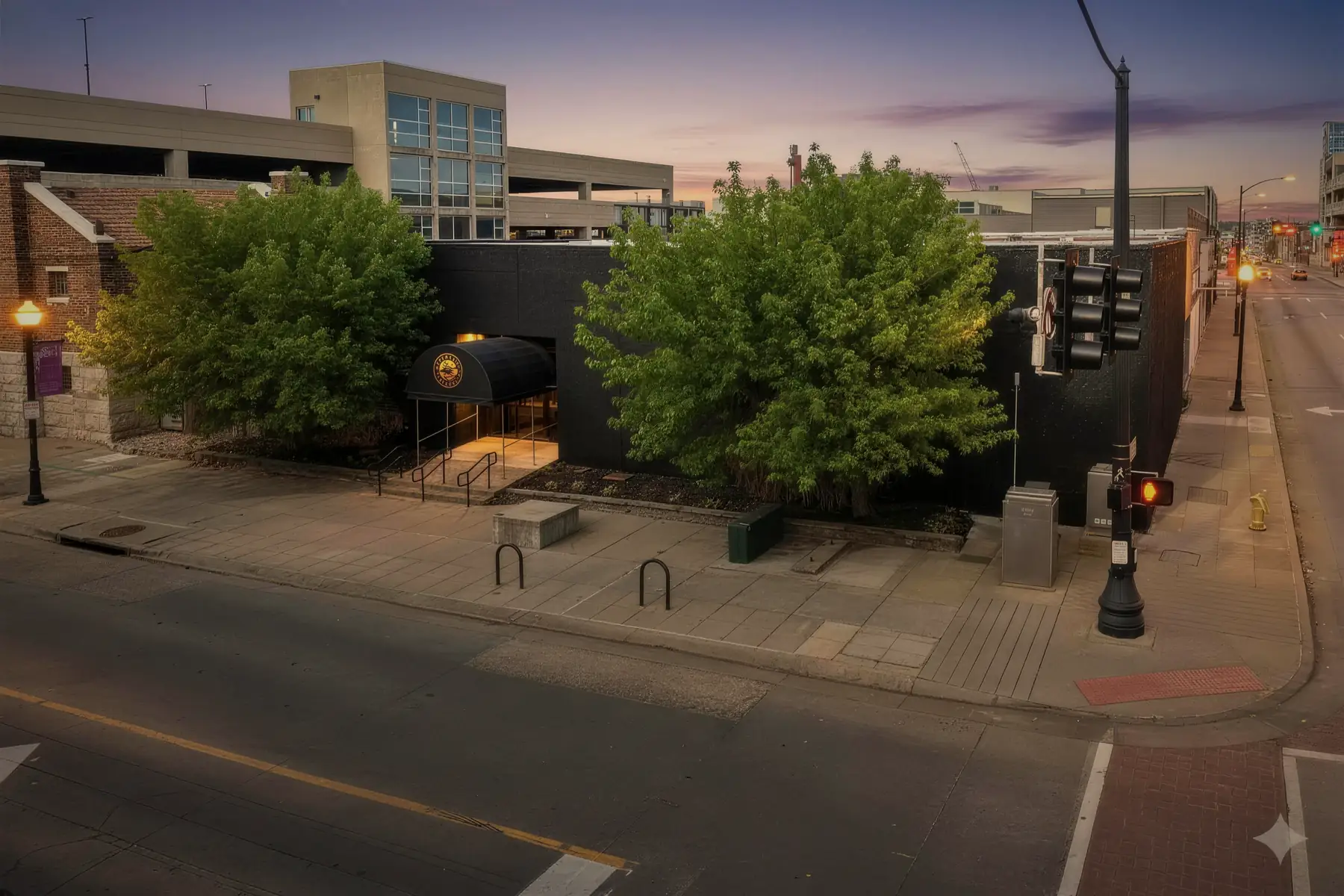 The Opus building at dusk, seen down West McDaniel with the street lights on.